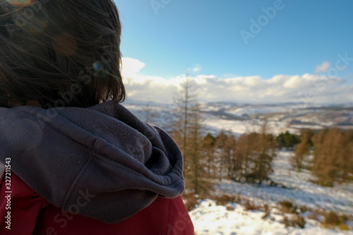 Woman on top of mountain in snow