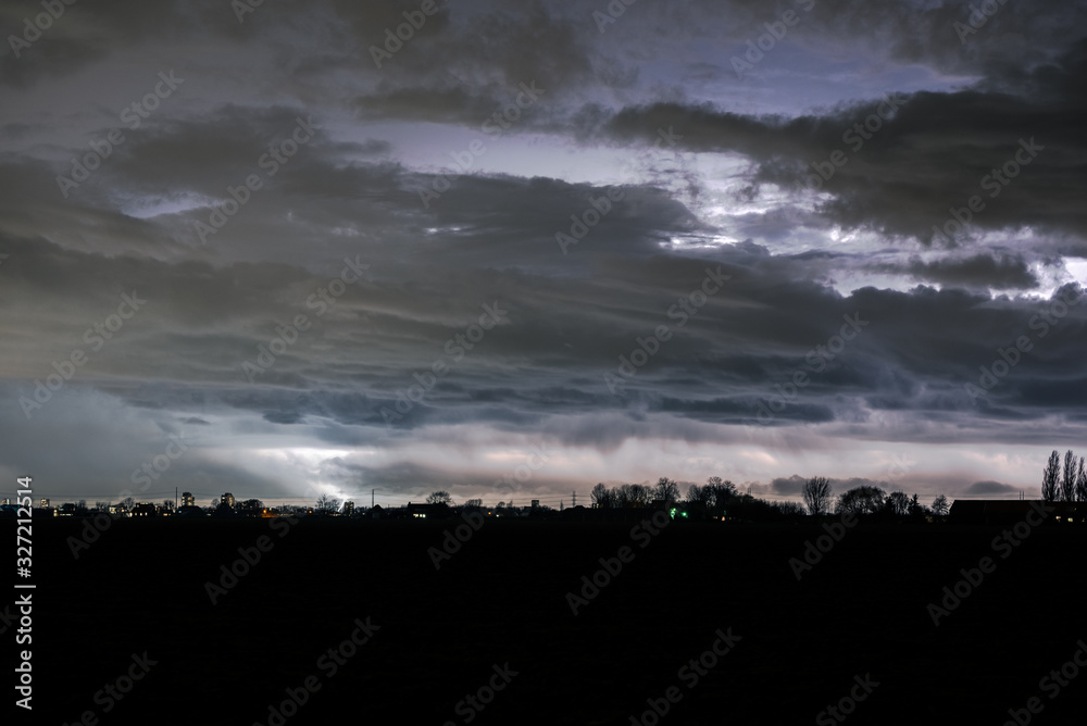 Dramatic clouds and lightning over the Netherlands at night Dramatic clouds and lightning over the Netherlands at night