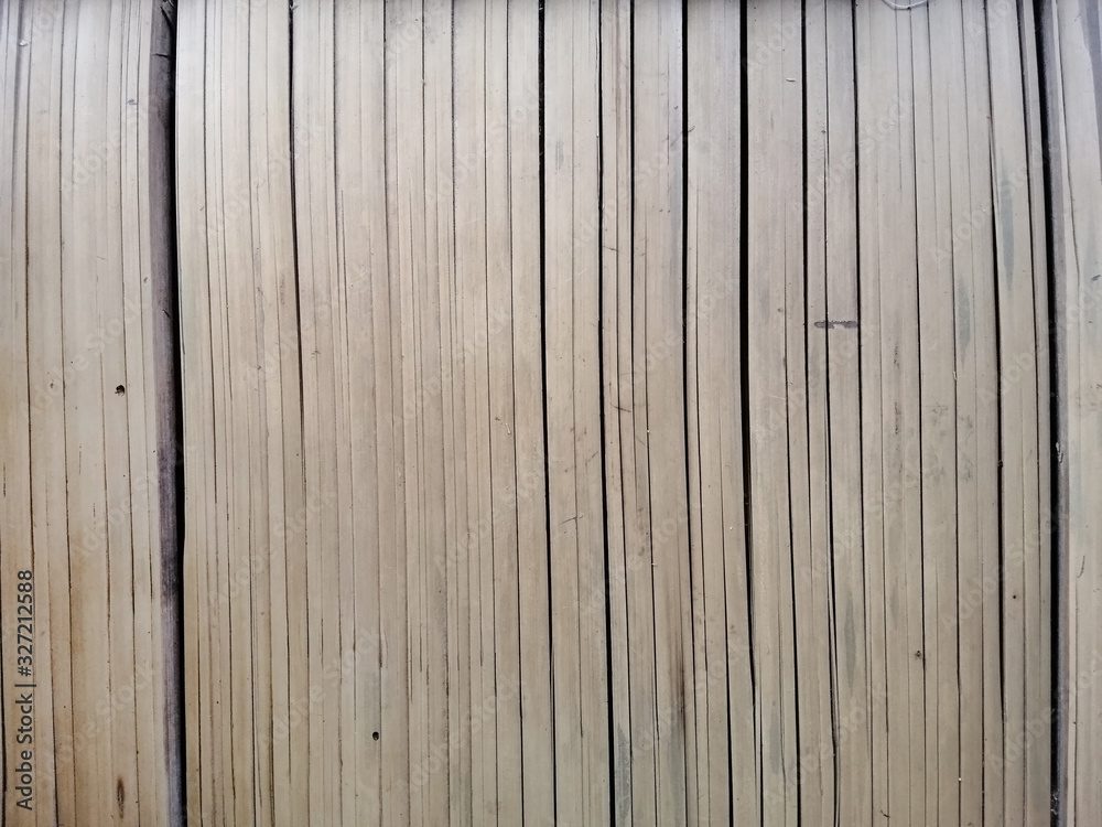 Naklejka premium old brown tone bamboo plank fence texture for background. vintage dry Bamboo wall background.