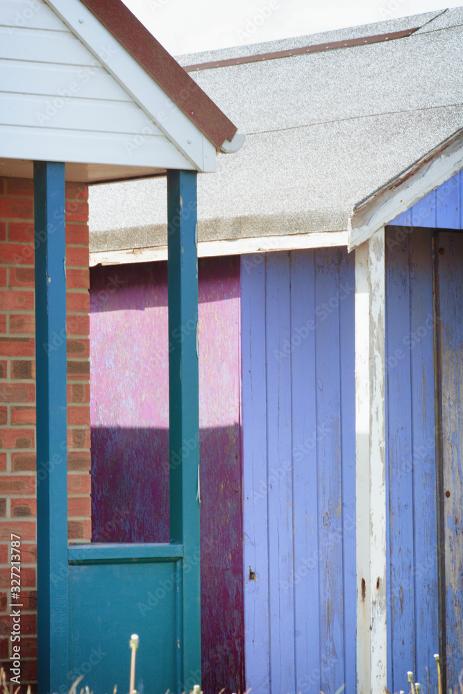 Abstract view of Beach huts. Sutton on Sea beach hut juxtaposition of colours and structure of huts. Various colours in vivid shades and brightness. Summertime holiday resort. Abstract view of Beach huts. Sutton on Sea beach hut juxtaposition of colours and structure of huts. Various colours in vivid shades and brightness. Summertime holiday resort.
