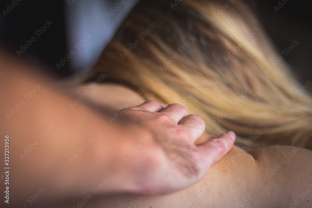 Woman at reflexotherapy massage made by man with hands Woman at reflexotherapy massage made by man with hands