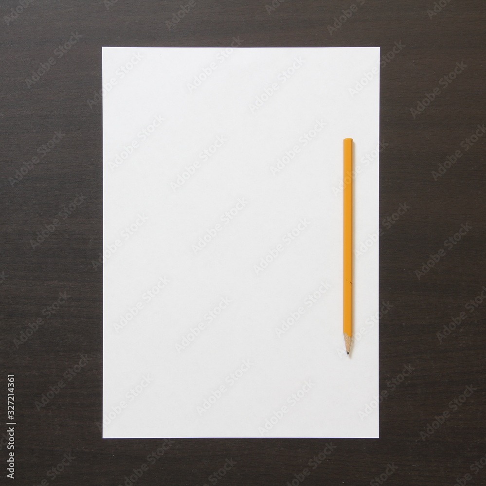 Template of white paper and pencil on dark wenge color wooden background. Template of white paper and pencil on dark wenge color wooden background.