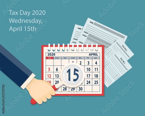 Calendar page April 2020,  hand and 15th is in magnifier  for tax day