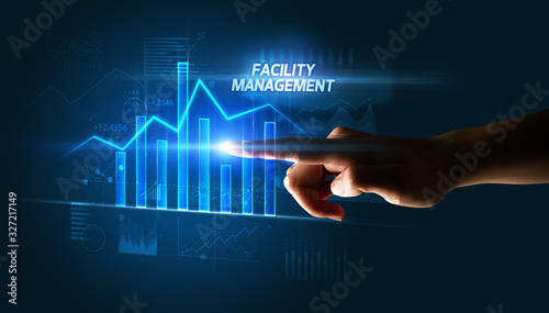 Hand touching FACILITY MANAGEMENT button, business concept