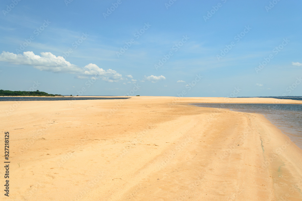 Interesting and particular river landscape in Brazil, in the state of Parà. A beach of clear sand and varying tongues of land depending on the movements of the water on the Amazon River.