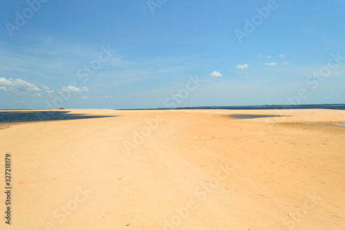 Interesting and particular river landscape in Brazil, in the state of Parà. A beach of clear sand and varying tongues of land depending on the movements of the water on the Amazon River. © eugpng