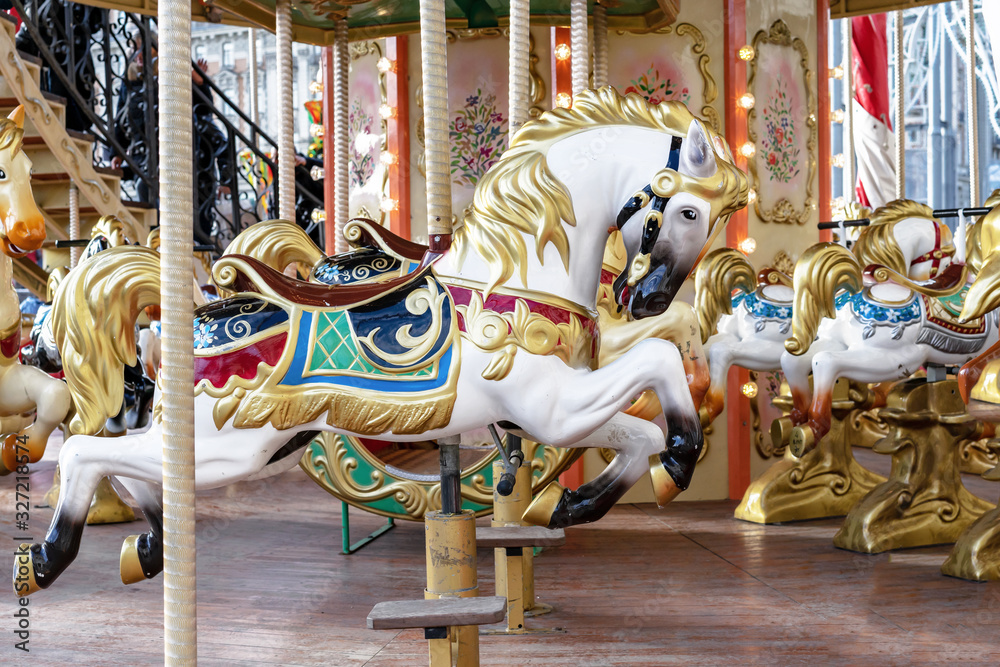 Horse in vintage style on a children's circular carousel.