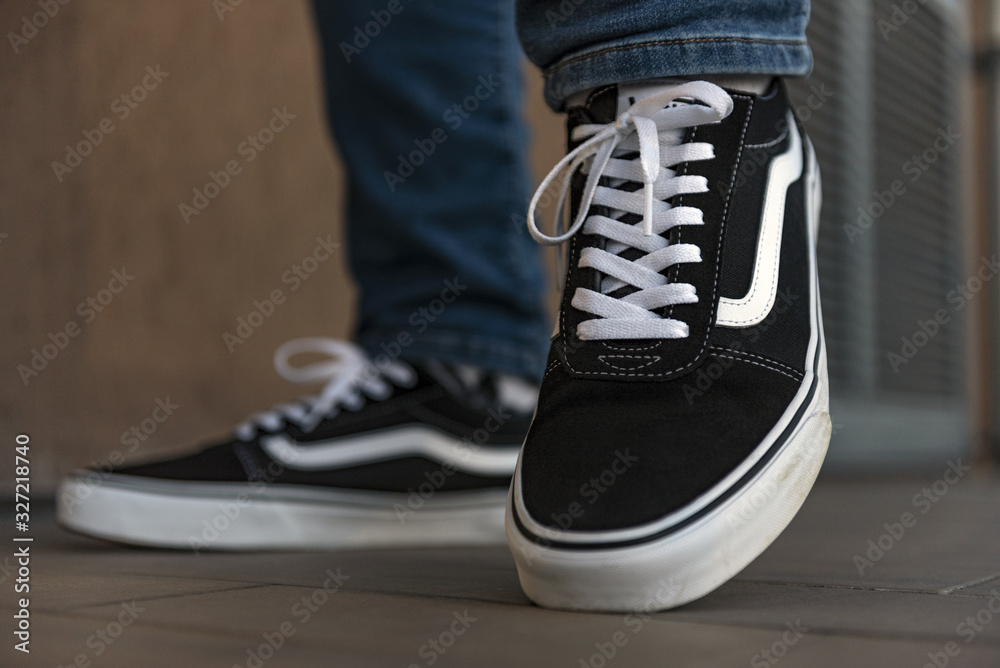 Young man wearing Vans Old Skool shoes outside Stock Photo | Adobe Stock