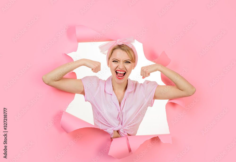 Girl showing his power. Woman flexing her muscles. Fitness girl