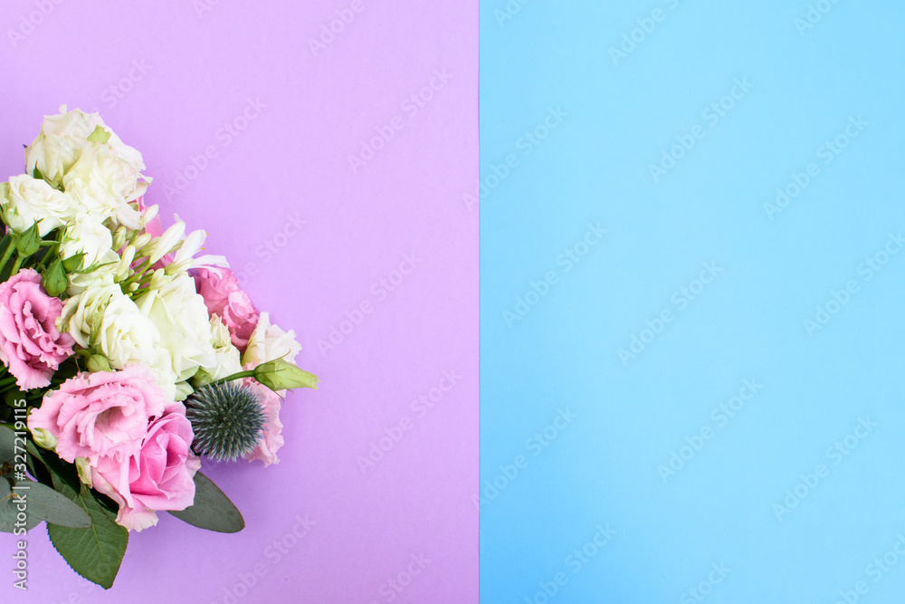 Colorful beautiful bouquet of different fresh flowers on the blue-violet background. Floral arrangement. Close up.