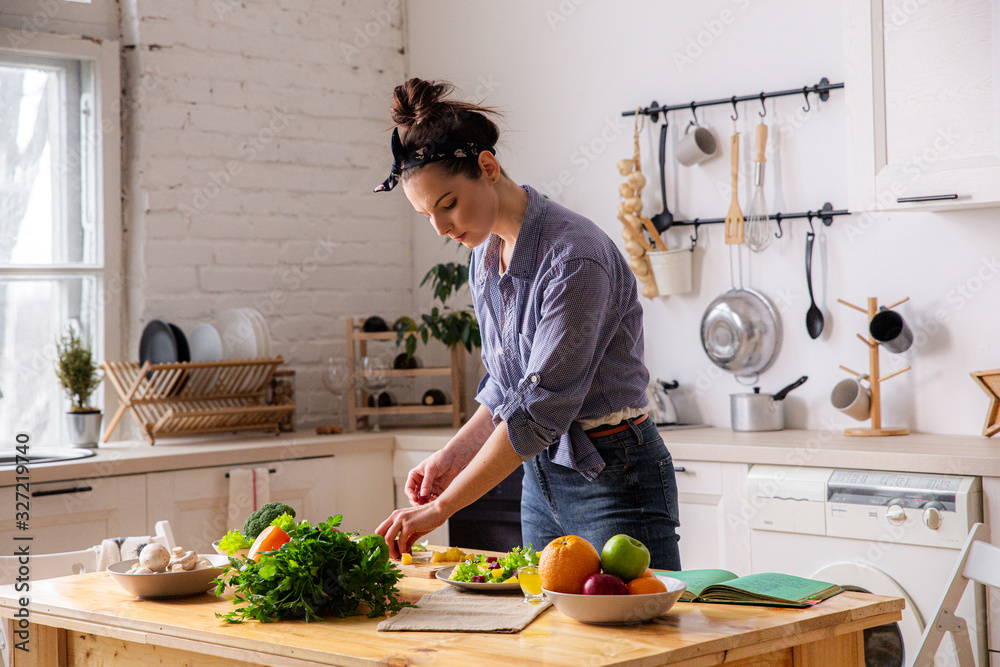 Young And Beautiful Housewife Woman Cooking In A White Kitchen Stock Young And Beautiful Housewife Woman Cooking In A White Kitchen Stock