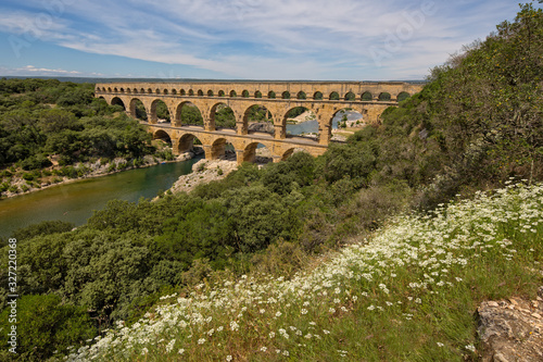 Pont du Gard is one of the most impressive samples of Roman architecture. Scenic view of ancient Roman aqueduct Pont du Gard over Gardon river near Nimes, Gard, Provence, France