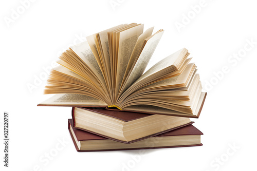 open book lies on other books isolated on white background