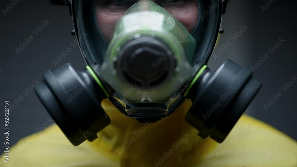 Caucasian Researcher Adjusts Face Mask And Gas Mask To Begin Dangerous Experiment.
