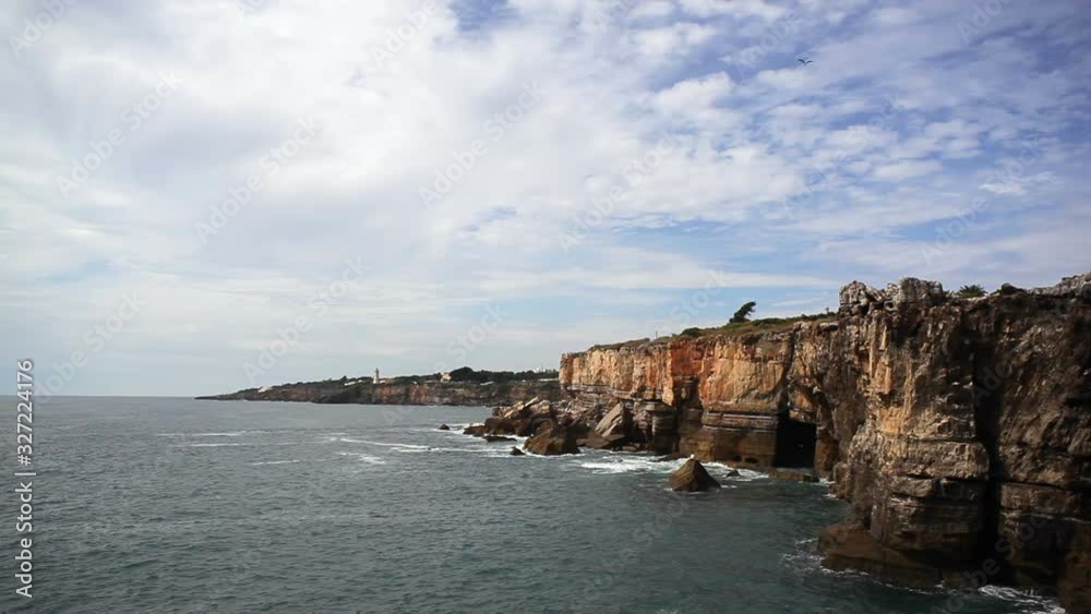 Waves hit rocky cliffs on the Atlantic ocean, long shot, Portugal Waves hit rocky cliffs on the Atlantic ocean, long shot, Portugal