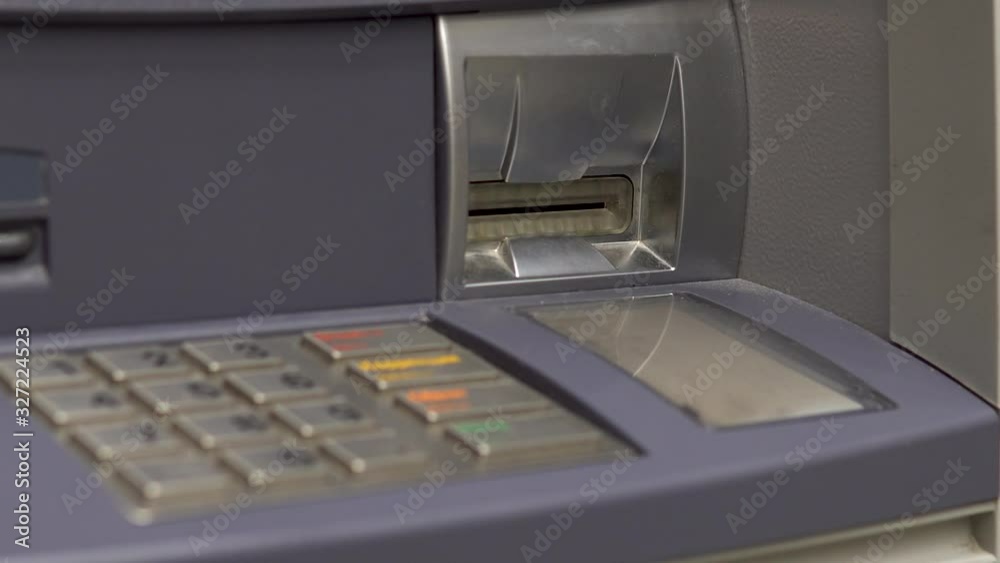 ATM close-up. ATM for cash withdrawal and deposit. The card entry slot blinks.