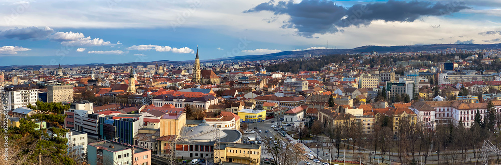 Aerial panoramic view of Cluj Napoca city over the famous cultural landmarks in town in a daytime , Romania