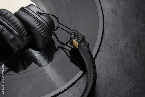 Over or on-ear headphones on vinyl record.