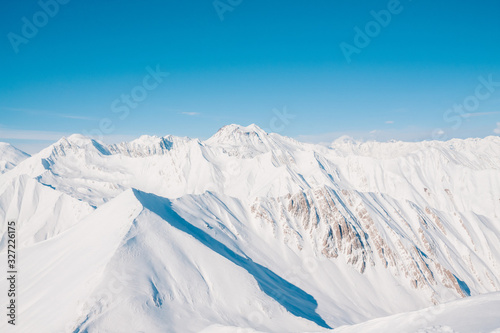 Snowy mountains in nice sun day. Caucasus Mountains, Georgia. View from ski resort Gudauri. © Olena