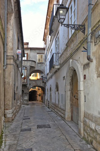 Fototapeta Naklejka Na Ścianę i Meble -  Sant'Agata de 'Goti, Italy, 02/29/2020. A narrow street between the old houses of a medieval village.