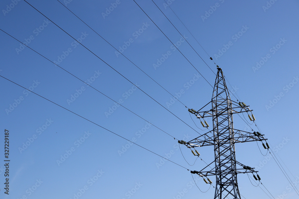 Power line against the blue sky. Electricity and sky. Power supply. Power line against the blue sky. Electricity and sky. Power supply.