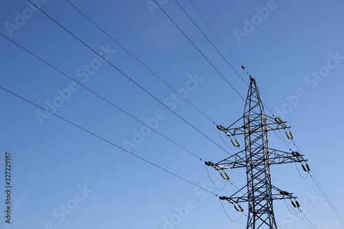 Power line against the blue sky. Electricity and sky. Power supply.