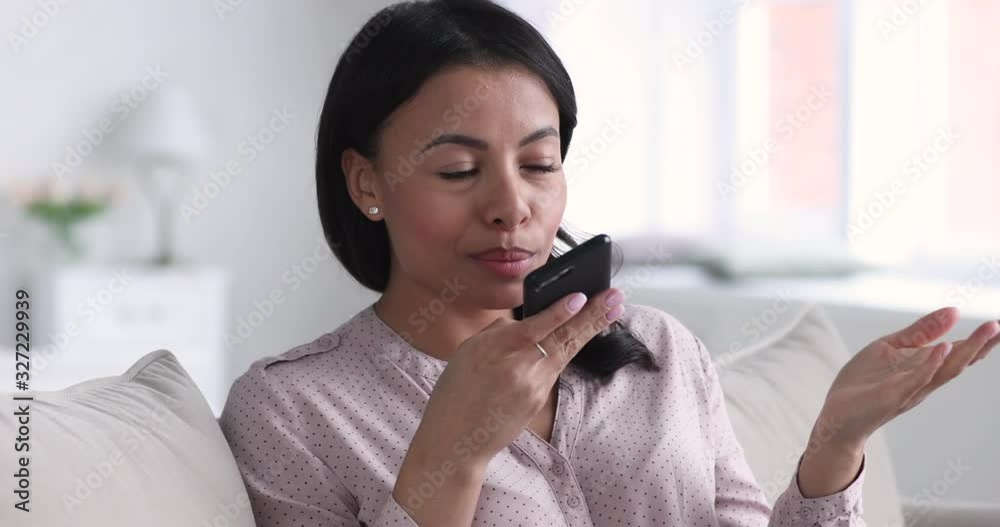 African woman recording voice message using virtual assistant on smartphone African woman recording voice message using virtual assistant on smartphone