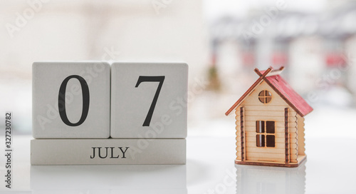 July calendar and toy home. Day 7 of month. Card message for print or remember