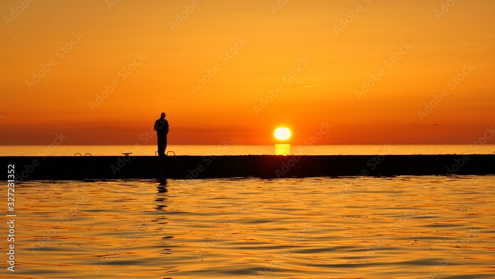 silhouette of man on sunset