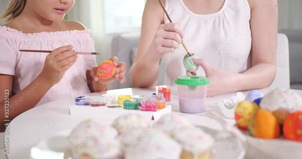 Mother and daughter painting Easter eggs, closeup Mother and daughter painting Easter eggs, closeup