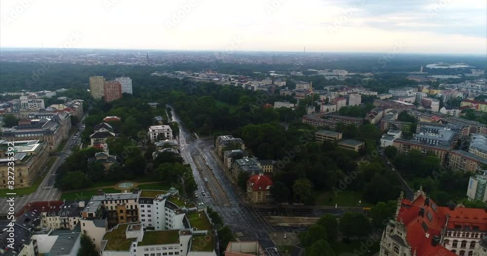 Flying a drone over the city of Leipzig. Aerial time lapse of down town. Early morning cityscape of Leipzig the largest city of Saxony, Germany. Drone hyper lapse on a rainy day 