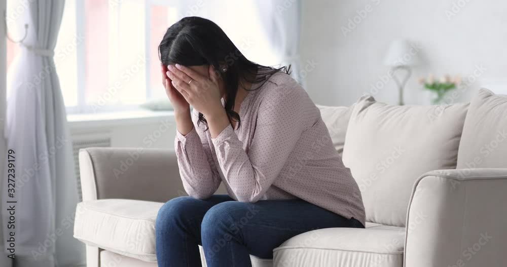 Depressed african woman suffer from stress sit alone at home Depressed african woman suffer from stress sit alone at home