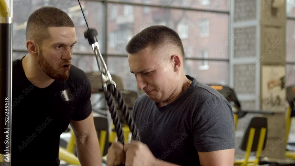 Young man shouted at by instructor while working out in gym Young man shouted at by instructor while working out in gym