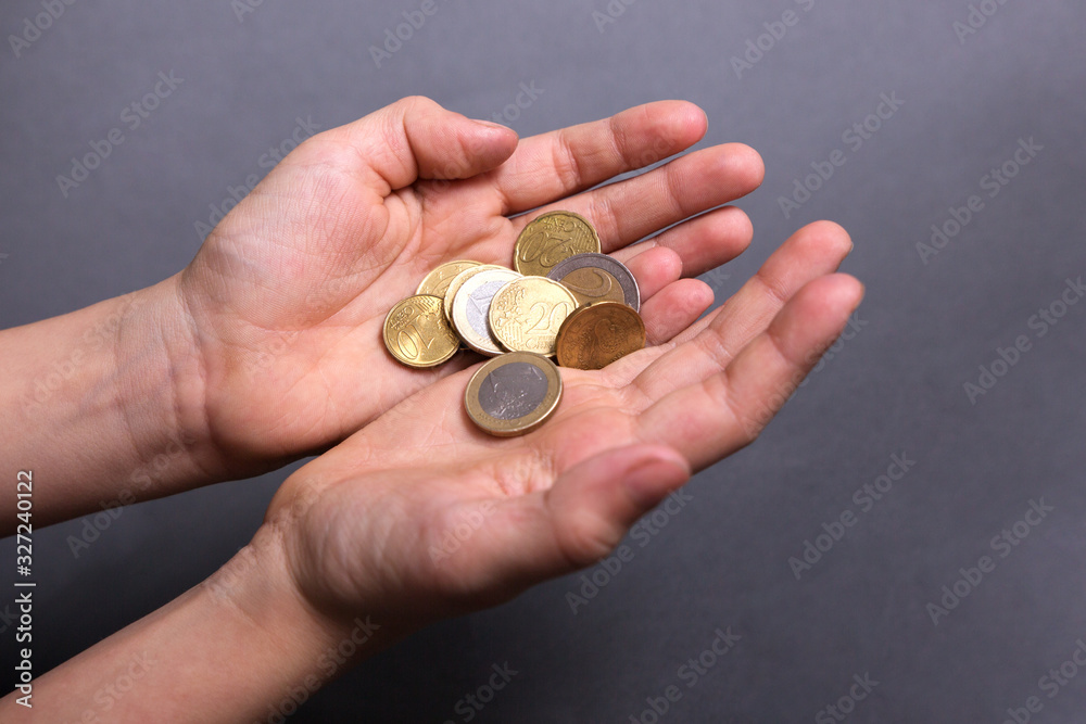 child hold in his little hands money euro on grey background child hold in his little hands money euro on grey background