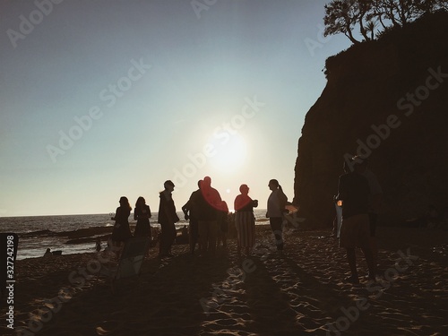 Group of people on a beach during sunset