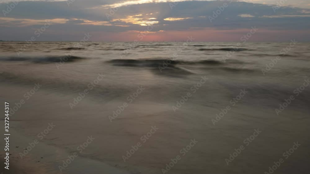 Sea waves on sandy beach, clouds on vivid sunrise sky, fast motion timelapse Sea waves on sandy beach, clouds on vivid sunrise sky, fast motion timelapse