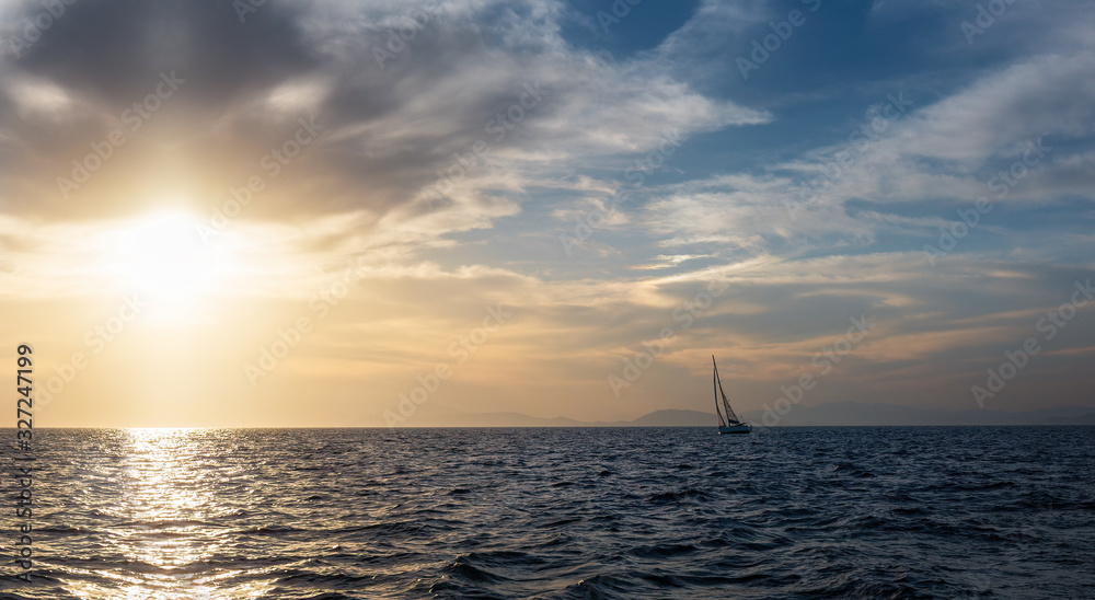 Silhouette Sail boat gliding in open sea at sunset. Tilted monohull in the evening. Luxury summer adventure, active vacation in Mediterranean sea Silhouette Sail boat gliding in open sea at sunset. Tilted monohull in the evening. Luxury summer adventure, active vacation in Mediterranean sea
