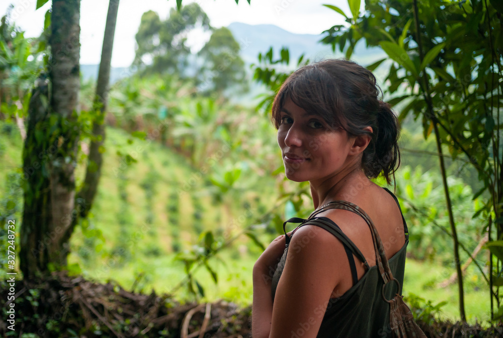 Brown and Latin Woman Looking at the Camera in a Agriculture Hill with Trees Surrounded Brown and Latin Woman Looking at the Camera in a Agriculture Hill with Trees Surrounded