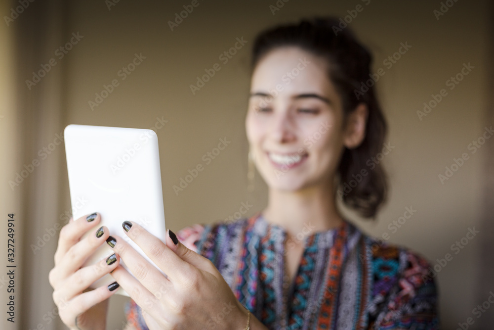 smiling woman reading digital book indoors. studying at home. smiling woman reading digital book indoors. studying at home.