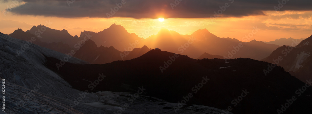 Dawn in the Caucasus Mountains, panorama landscape. Ridge, sharp peaks. Traveling in the mountains, trekking.