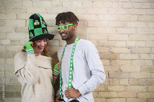 Happy Young Couple Wearing Costumes to Celebrate St. Patrick's Day.