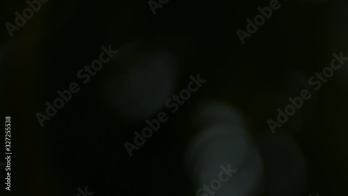 Abstract light leaks on black background, sunlight bokeh with lens flare.