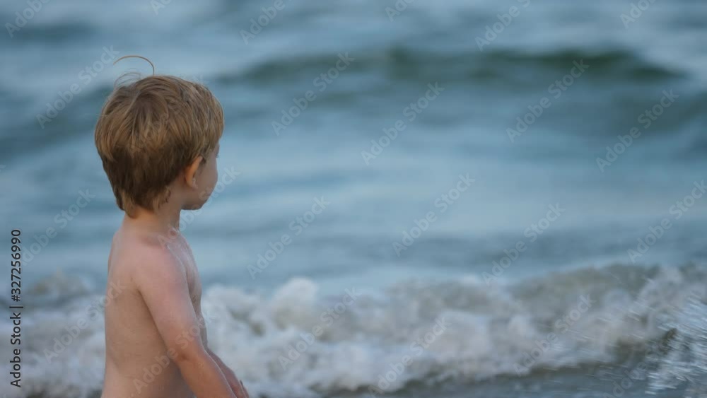 Funny child splashing sea water, slow motion Funny child splashing sea water, slow motion