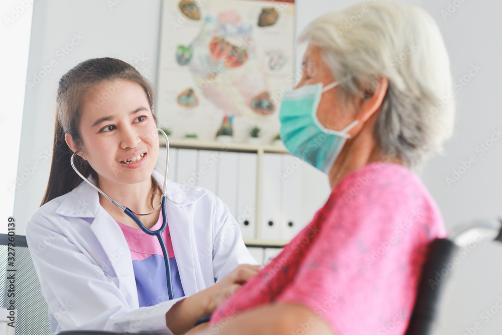 Asian Old Patient woman Talking with Medical Doctor women in clinic office hospital Asian Old Patient woman Talking with Medical Doctor women in clinic office hospital