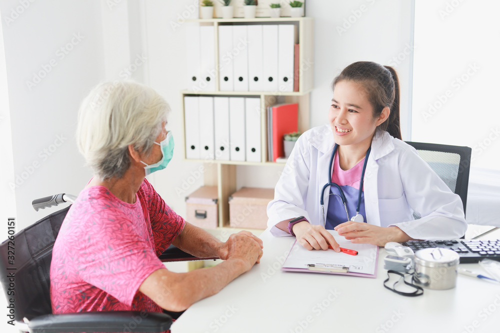 Fototapeta premium Asian Old Patient woman Talking with Medical Doctor women in clinic office hospital