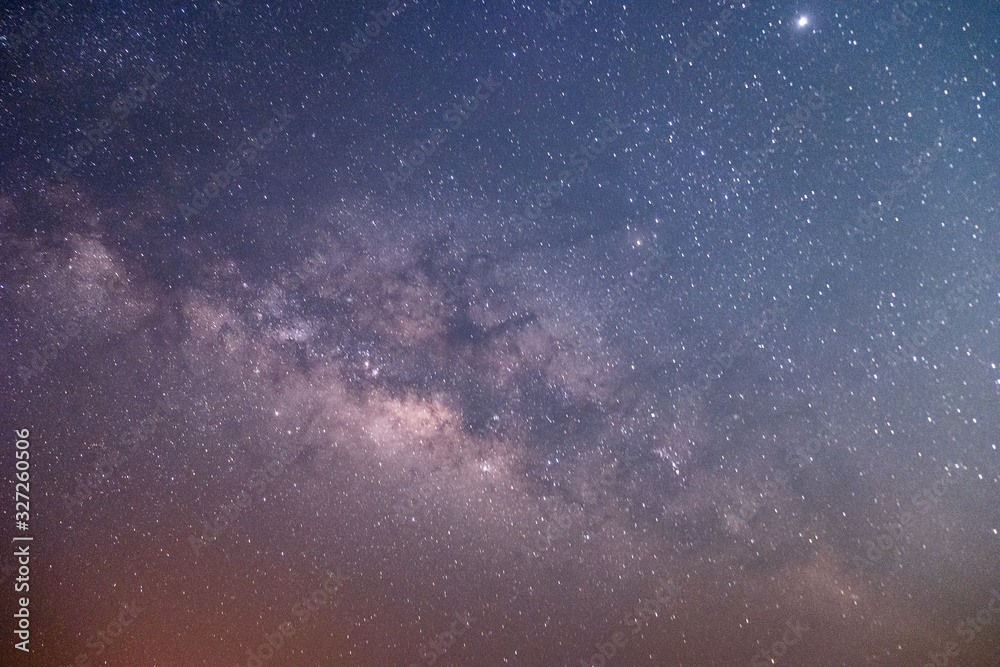 Fototapeta premium The stars and the milky way in the dark sky at night are very beautiful.