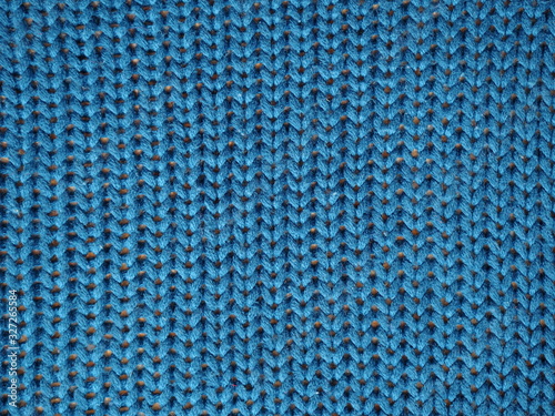 Blue knitted textured background, knit with facial loops.