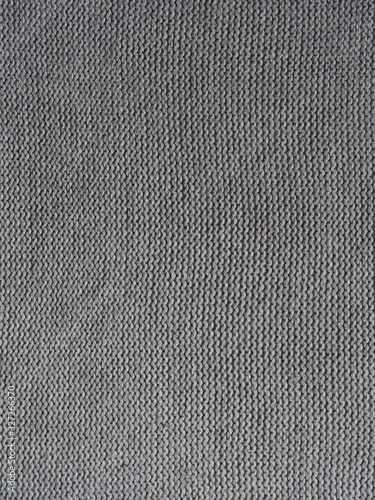 Gray knitted textured background, knit with purl loops. Hand knitting.