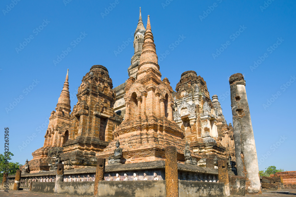 Ruins of chedi of the Buddhist temple Wat Mahathat close up on a sunny day. Sukhothai, Thailand