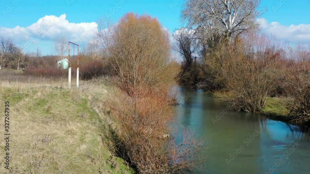 drone lateral flight over the small river with broken bridge drone lateral flight over the small river with broken bridge